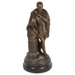A patinated spelter figure, a study of a Tudor gentleman leaning against a pillar, on turned wood