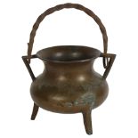 A bronze cauldron with wrought-iron swing handle, diameter 17cm