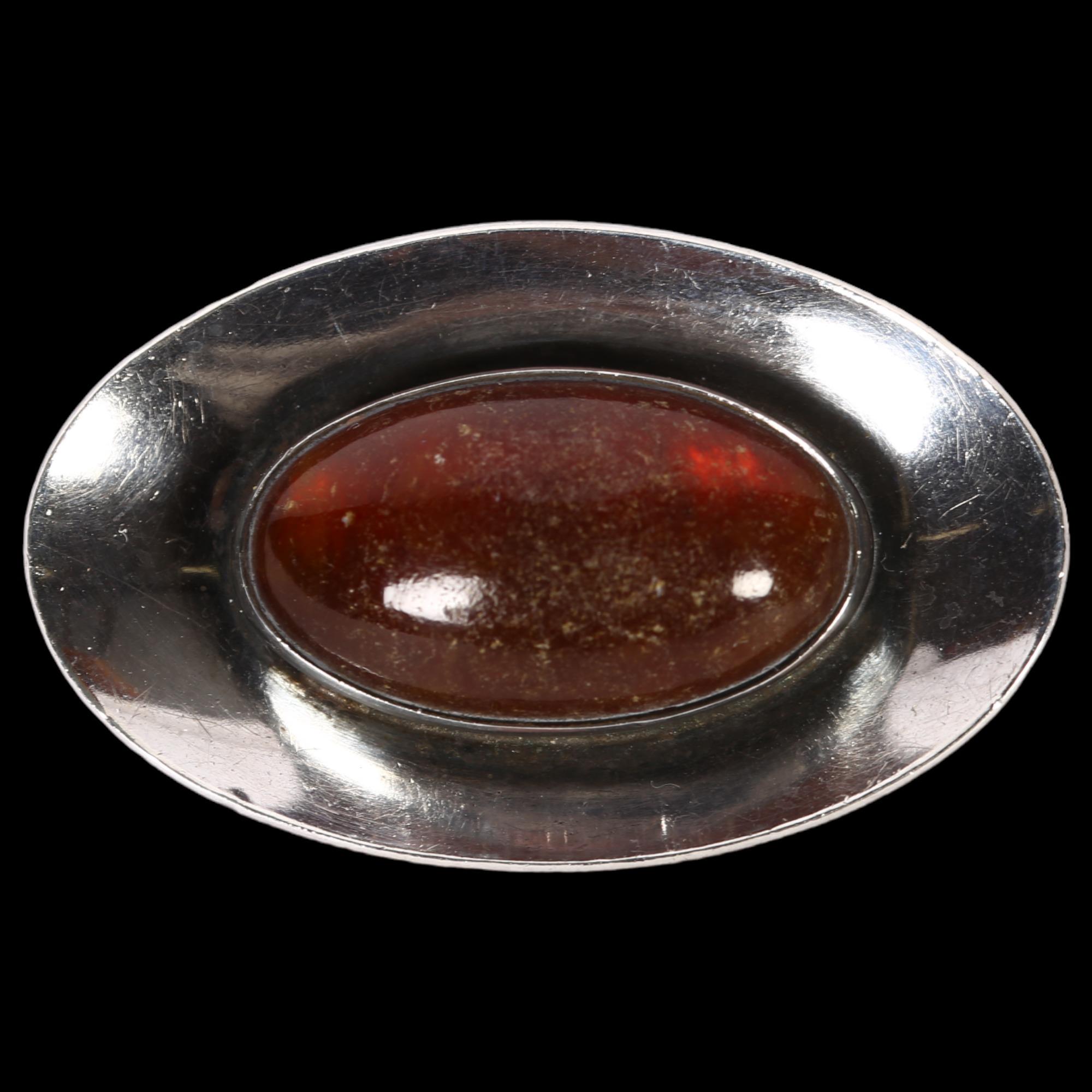NIEL ERIK FROM - a sterling silver and oval amber set shaped brooch