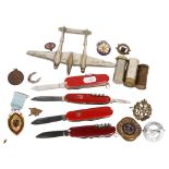 A group of various items, including a Swiss Army knife and 3 others, various badges including the