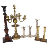 A quantity of various candlesticks and candelabras, including a large 4-branch brass candelabra,