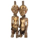 A pair of West African carved wood figures, tallest 44cm Natural faults in the wood, no repairs