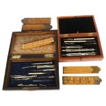 2 cased sets of draughtsman's instruments, and 5 folding Rabone rules