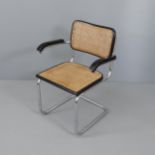 A mid-century desk chair in the manner of Marcel Breuer, on tubular steel frame with cane panels.