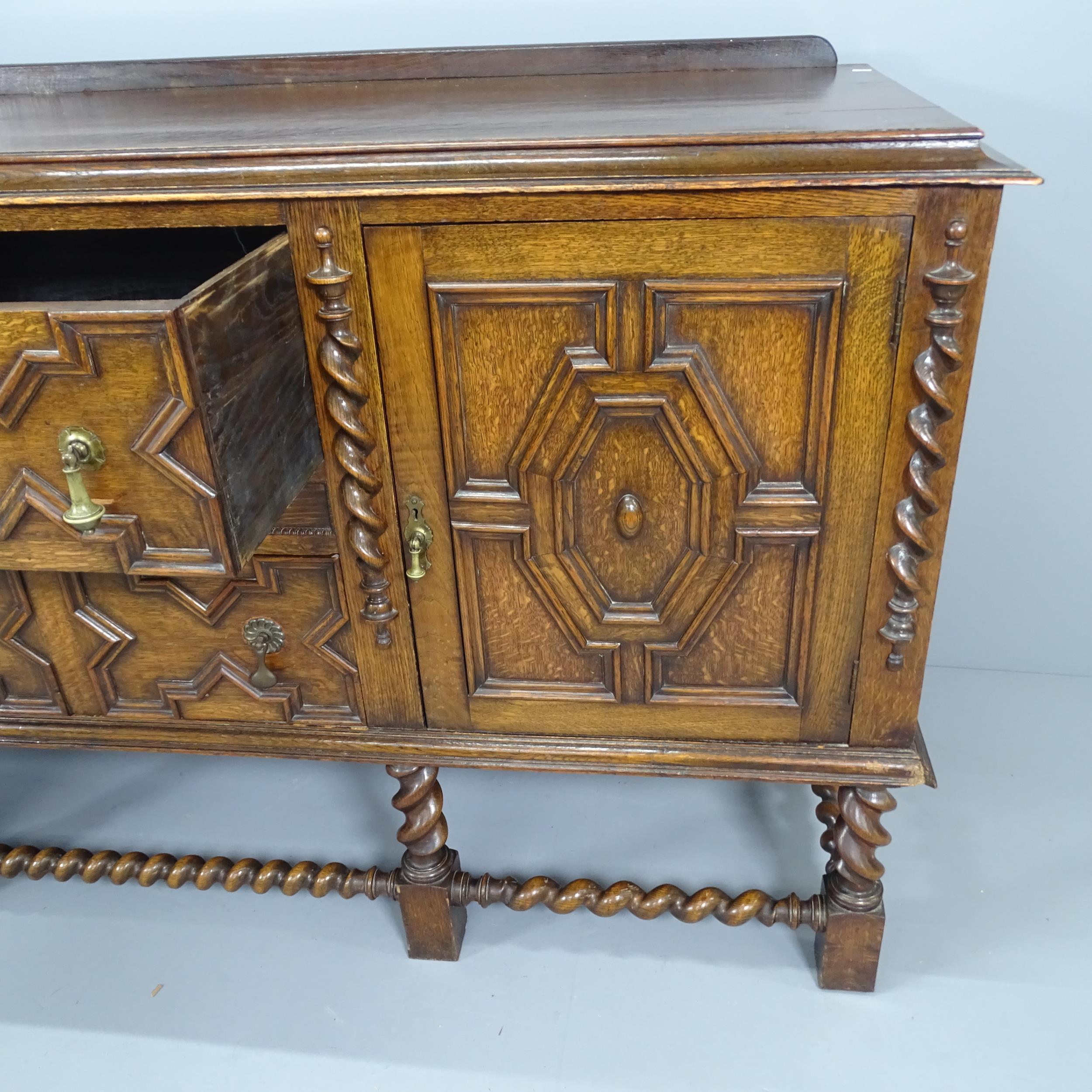 An early 20th century oak Jacobean style barley-twist sideboard with applied carved decoration. - Image 2 of 2