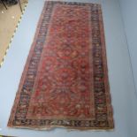 A red and blue-ground Keshan rug. 310x156cm Visible areas of wear and discolouration. Damage to