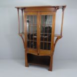 An Arts & Crafts / Art Nouveau display bookcase cabinet in the manner of Liberty & Co. 140x192x36cm.
