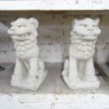 A pair of modern composite garden statues in the form of Dogs of Foo. Height 47cm.
