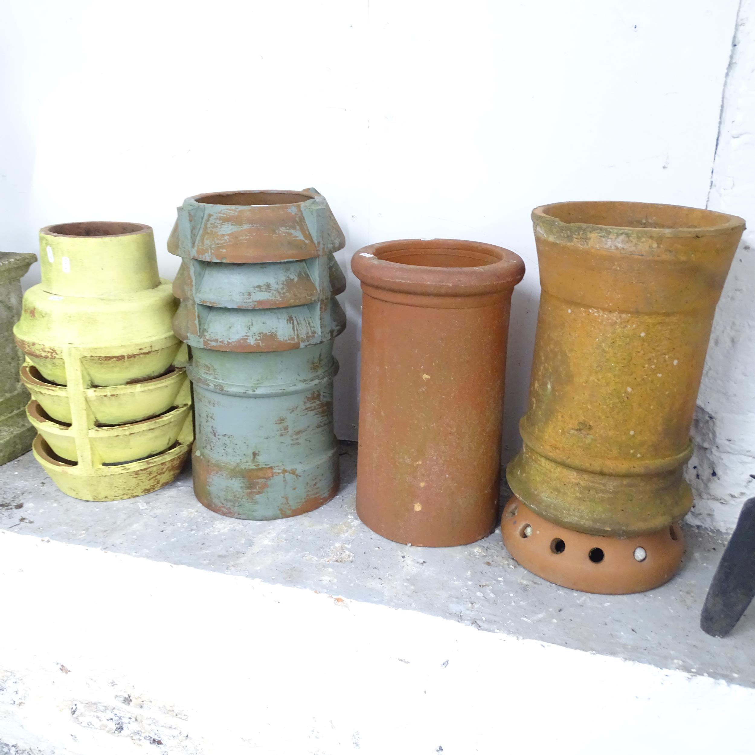 Four various terracotta chimney pots. Tallest 55cm.