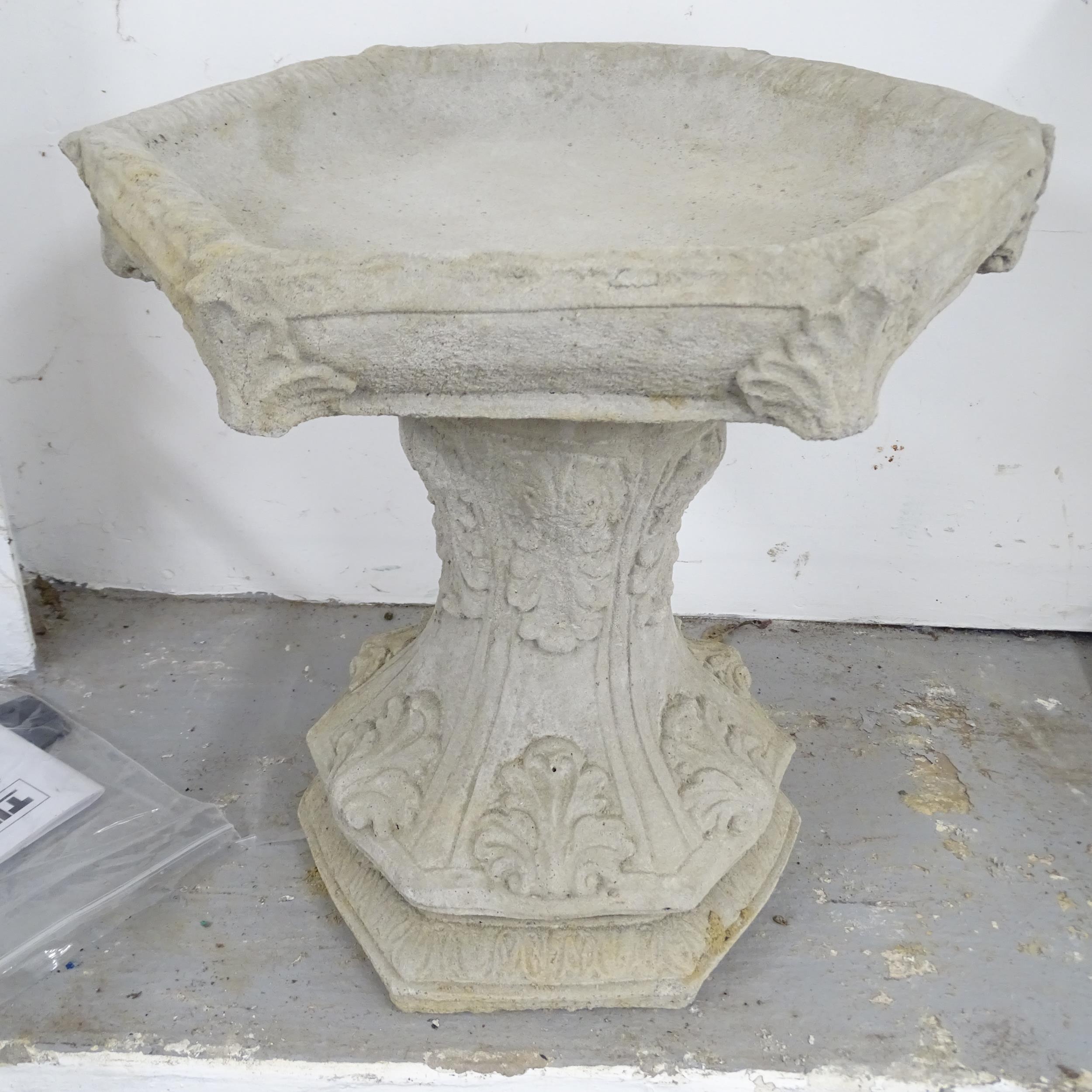 A two-section concrete bird bath with hexagonal top. 47x42cm