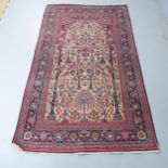 A blue and red ground Persian prayer rug. 220x130cm