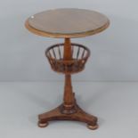 A Georgian mahogany knitting table, with rotating under-tier, with turned central column, platform