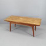A mid-century teak metamorphic coffee /dining table, with rise and fall mechanism and two drawing