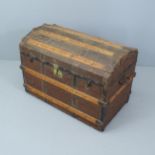A Victorian dome top trunk, with tray fitted interior and various travel labels to the interior