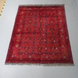 A red-ground Baluchi rug. 200x155cm Some areas of fading and wear. Fringe appears to have been
