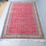 A red-ground Sarouk carpet. 295x200cm