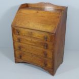 An early 20th century oak Bureau, the fall front revealing a fitted interior with three drawers