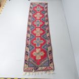 A red-ground Oushak runner. 280x73cm. Some loss to fringe. Appears to have been stored somewhere