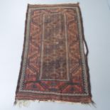 A salmon and brown ground Baluchi rug, 183x105cm.