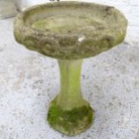 A weathered concrete two-section bird bath. 38x53cm