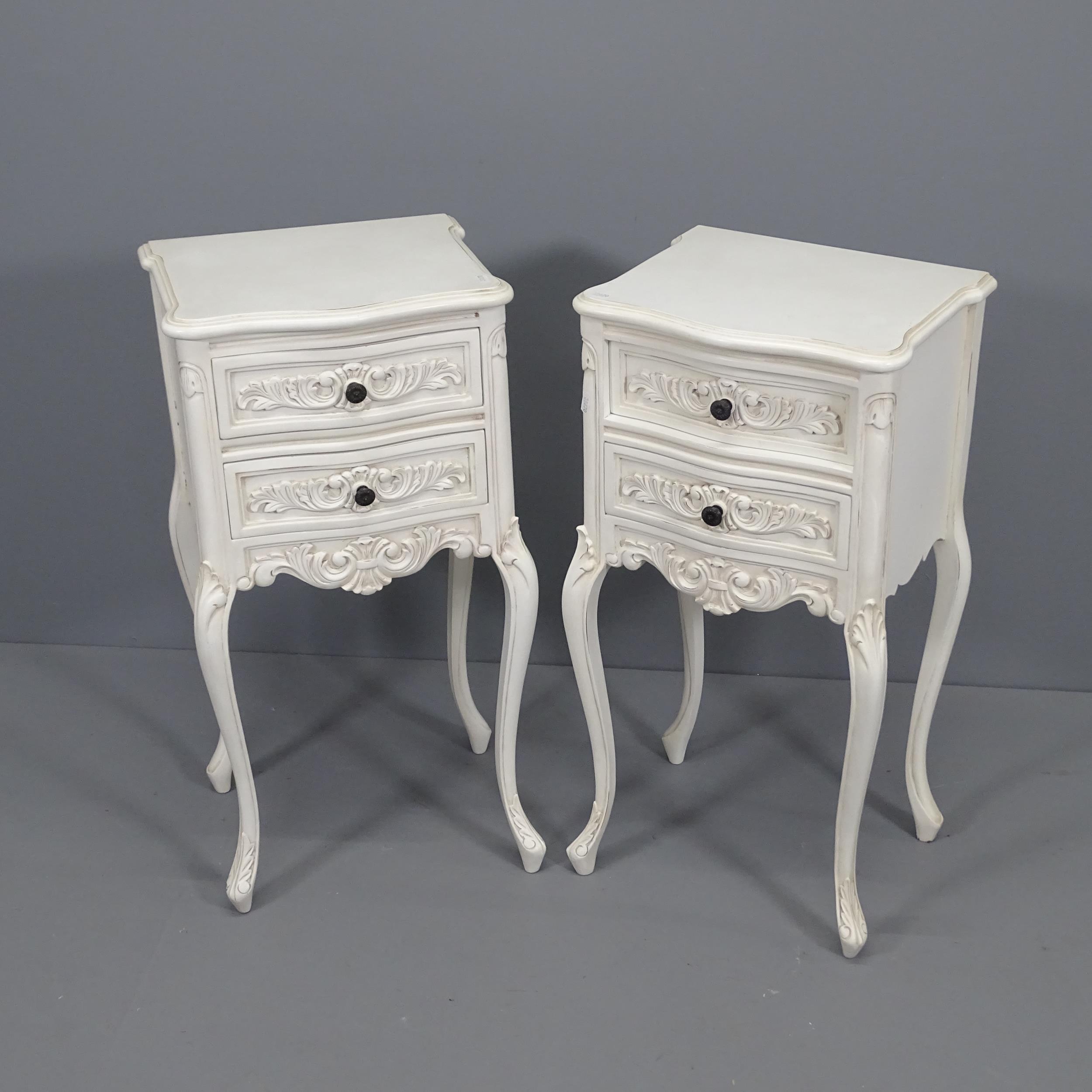 A pair of French style painted 2-drawer bedside chests with maker's label to underside for Coach