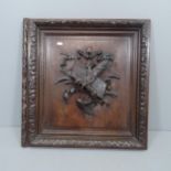 A carved oak armorial wall plaque. 62x65x6cm