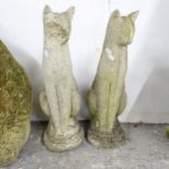 A pair of weathered concrete cat statues. Height 57cm One cat's face has been damaged.