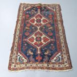 A red and blue-ground Persian rug. 158x102cm Faded all over. Visible areas of wear and fringe loss.