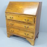 An Edwardian crossbanded mahogany and satinwood strung bureau, with inlaid shell decoration, the