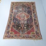 A red and blue-ground Persian rug. 221x138cm Heavily worn and faded.
