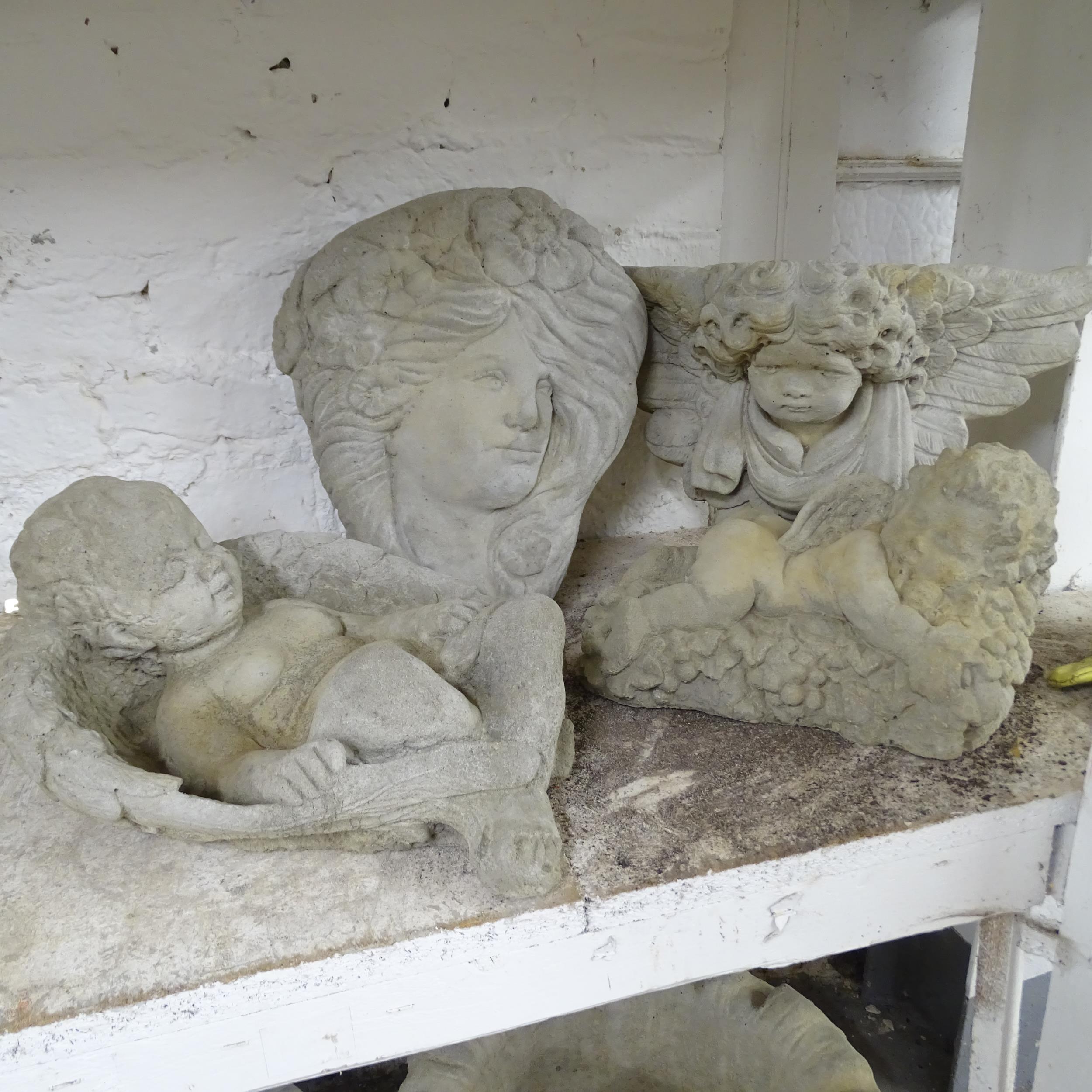 Four various concrete garden ornaments including a Baccus cherub, length 26cm, A wall plaque in