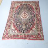 A cream ground Persian Hamadan rug. 204x133cm