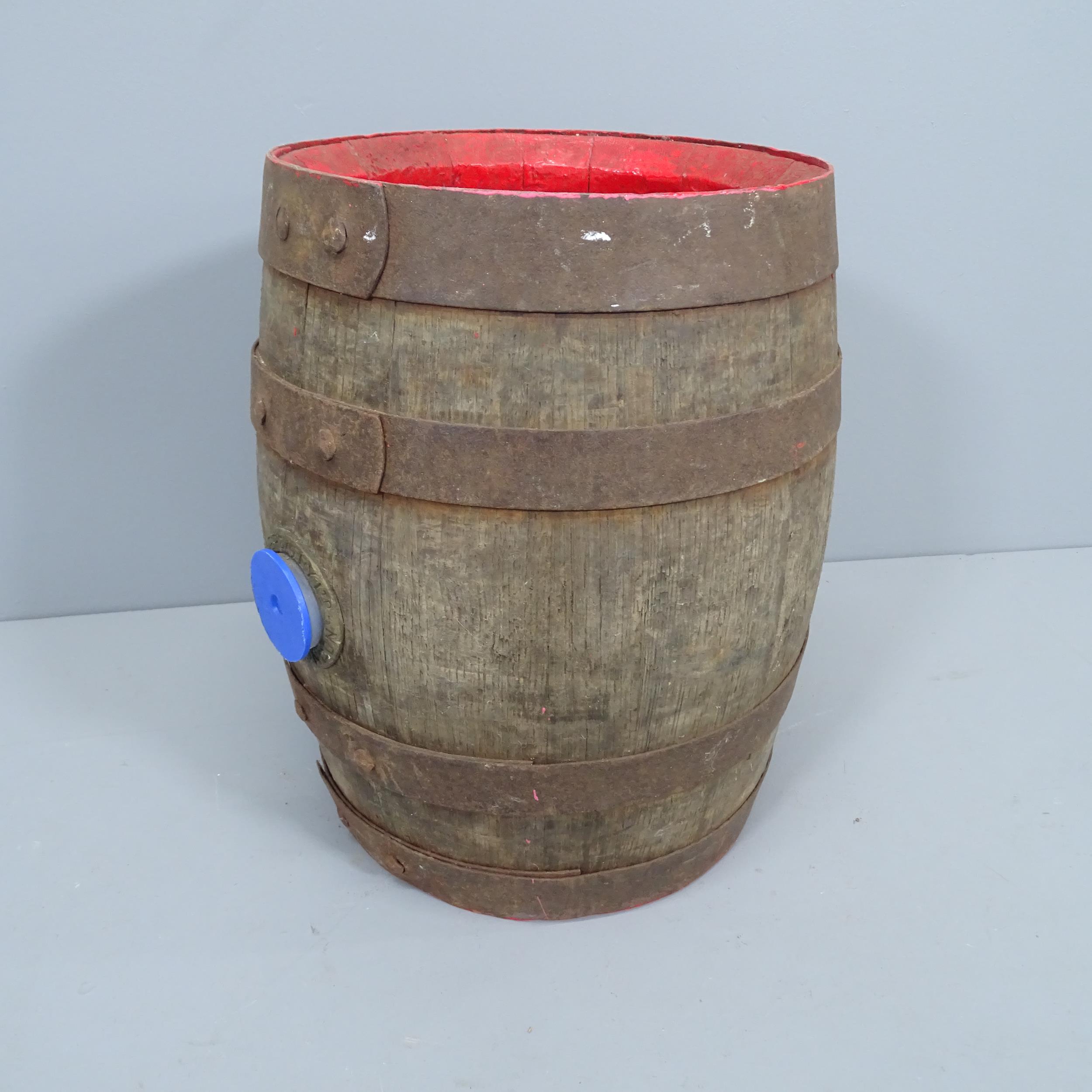 A vintage coopered oak barrel, with impressed marks for Young & Co. Brewery of London. Height 43cm.