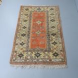 A cream-ground Caucasian rug. 190x120cm.