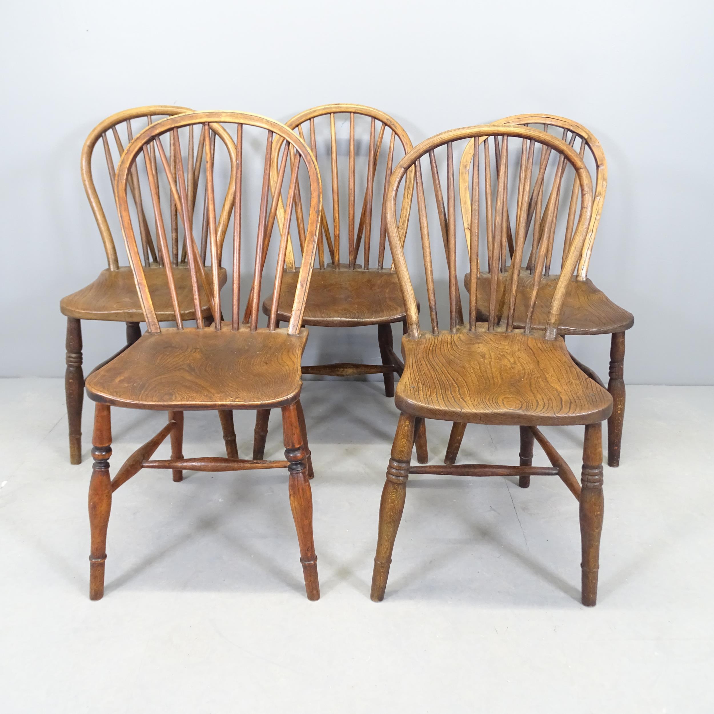 Five early 19th century Windsor chairs in yew, ash and elm, with various stamped marks.