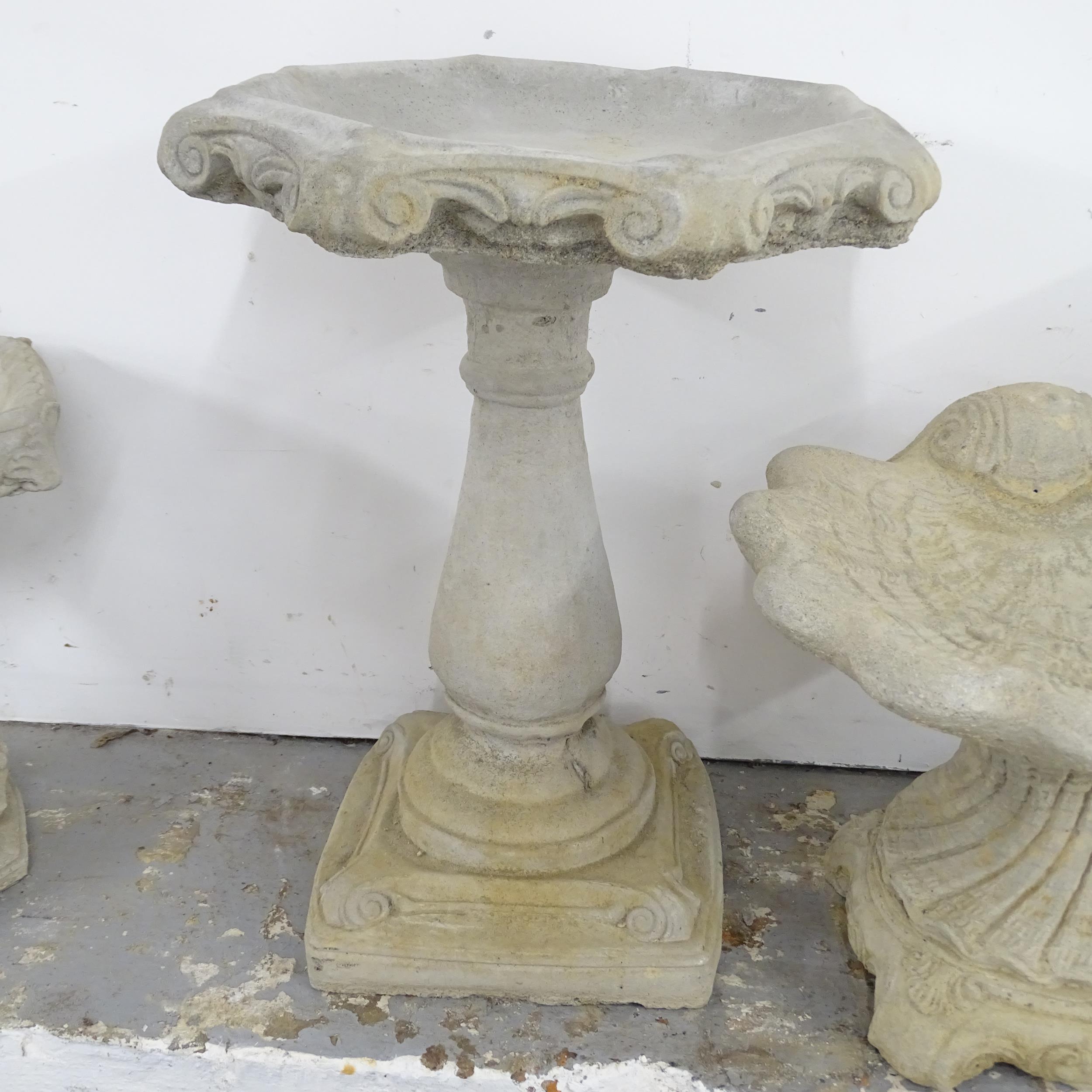 A two-section concrete bird bath with scroll decoration. 49x67cm