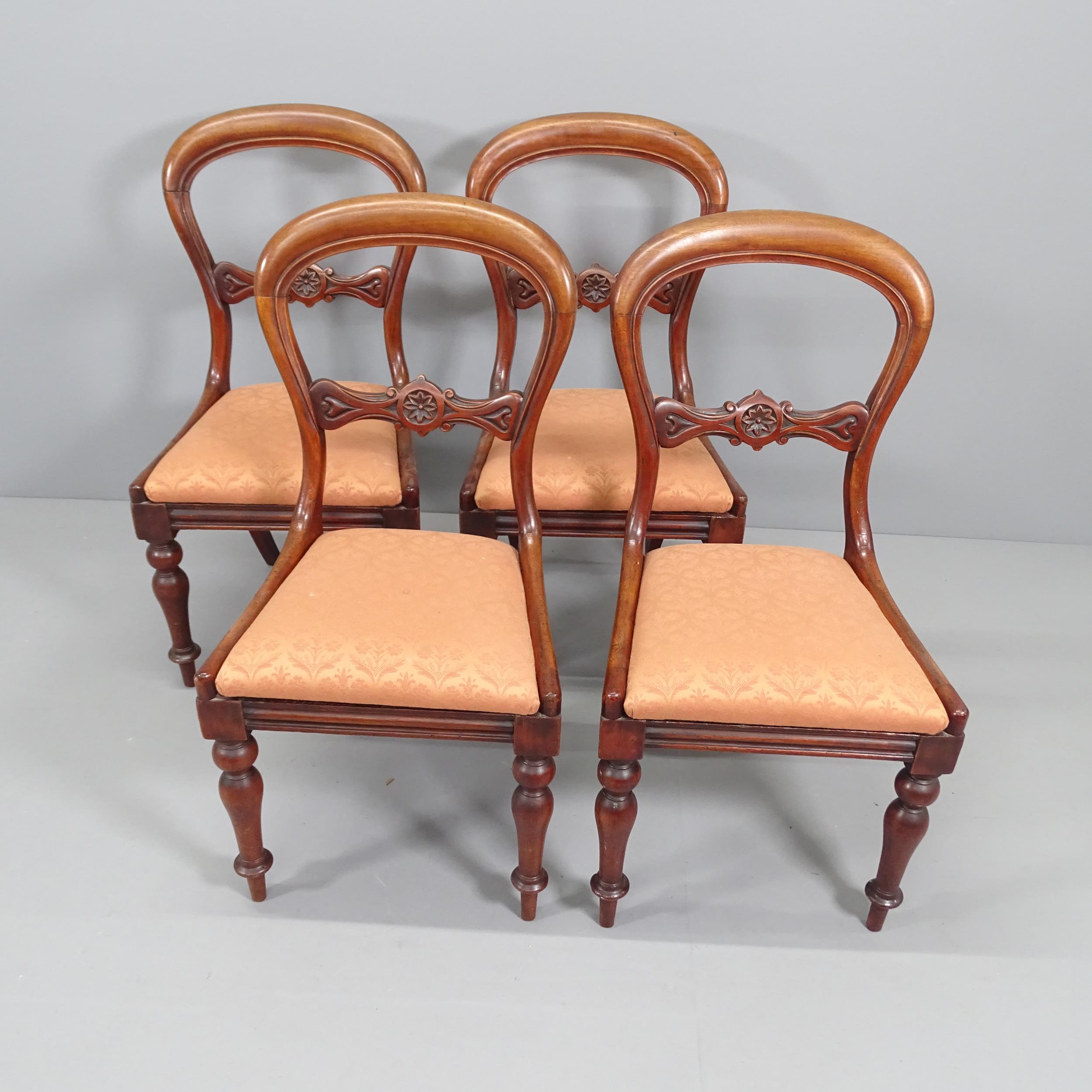 A set of four 19th century mahogany balloon back dining chairs with drop-in seats. Various repairs