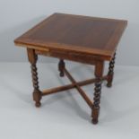A 1920s oak draw-leaf dining table, on barley-twist legs with x-shaped stretcher. 76 (extending to