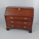 A Georgian mahogany two-section bureau, the fall front revealing a fitted interior with three long