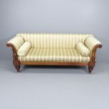 A Regency mahogany-framed and silk upholstered sofa, with roll-over arms and carved decoration.