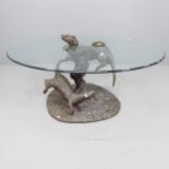 Mark Stoddart, a bronze otter design coffee table with oval glass top. 115x55x87cm.