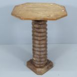 A French elm octagonal occasional table, mounted on spiral turn central column with carved base.