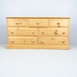 A modern pine chest of three short and four long drawers. 150x75x45cm