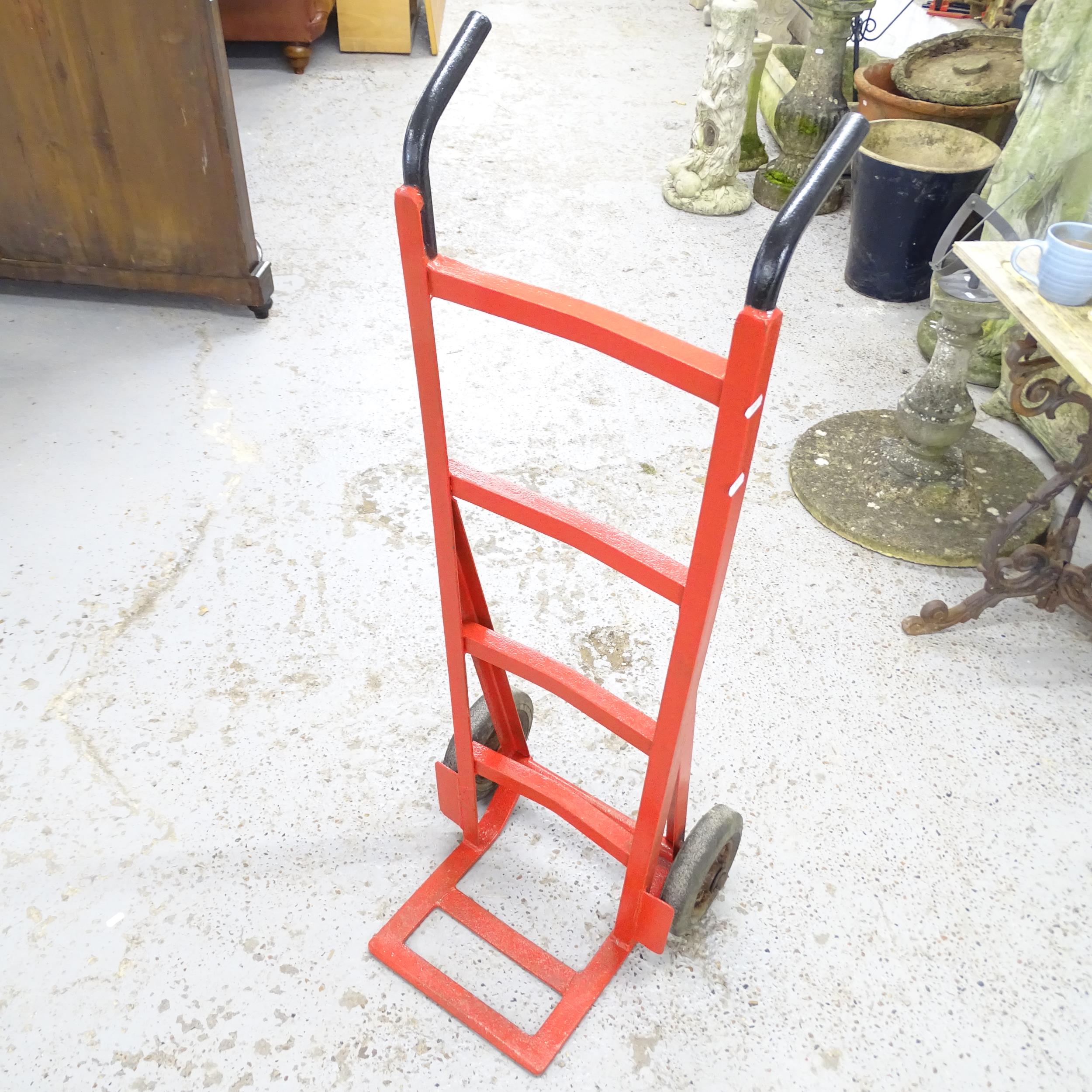 A painted metal sack barrow.