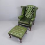 A Green leather upholstered buttoned wing back fireside armchair and a matched green leather