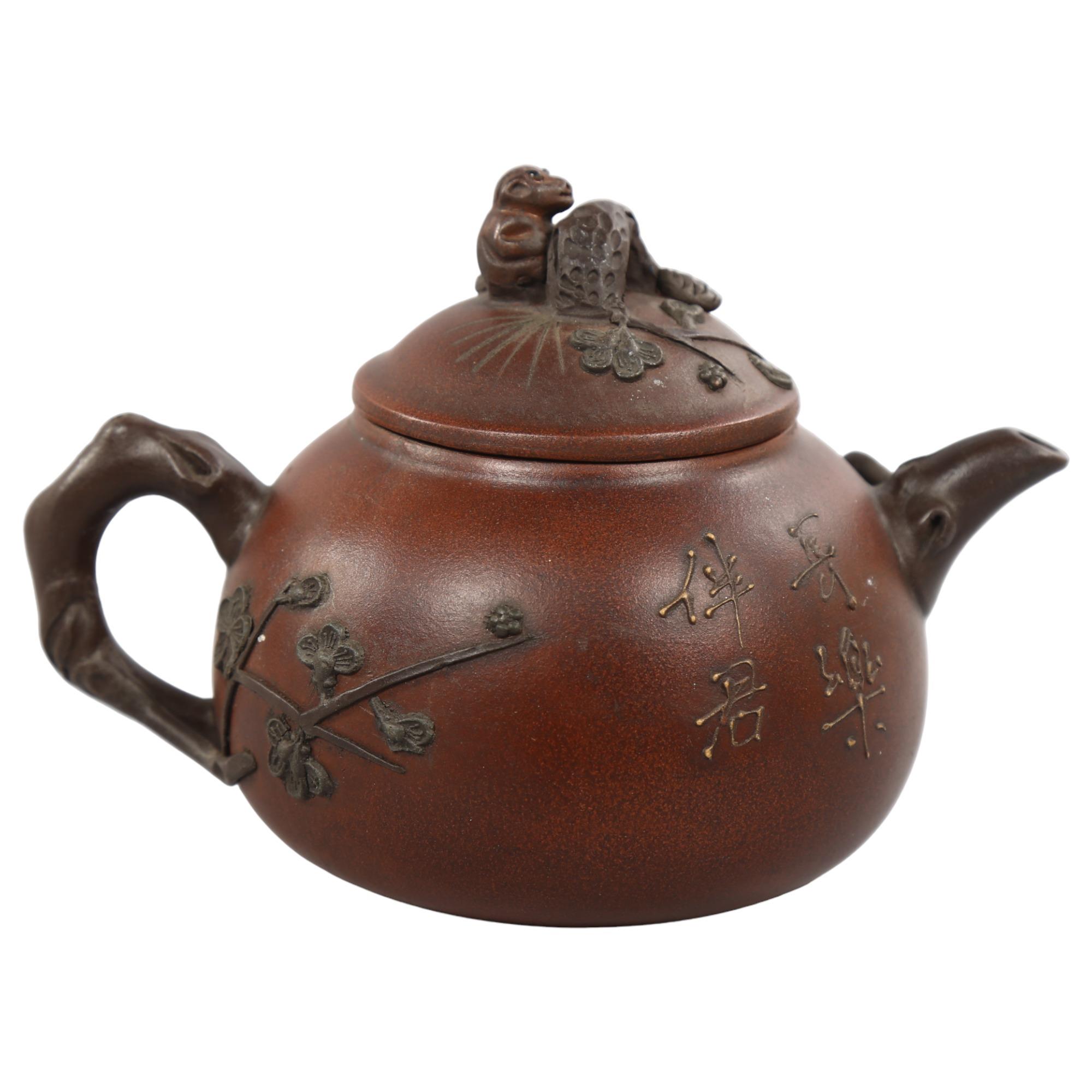A Chinese Yixing teapot with monkey knop, character marks to base and sides, height 12cm Good