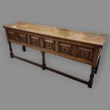 18th century oak dresser base, the top having 3 inset botanical marquetry panels, allover checker