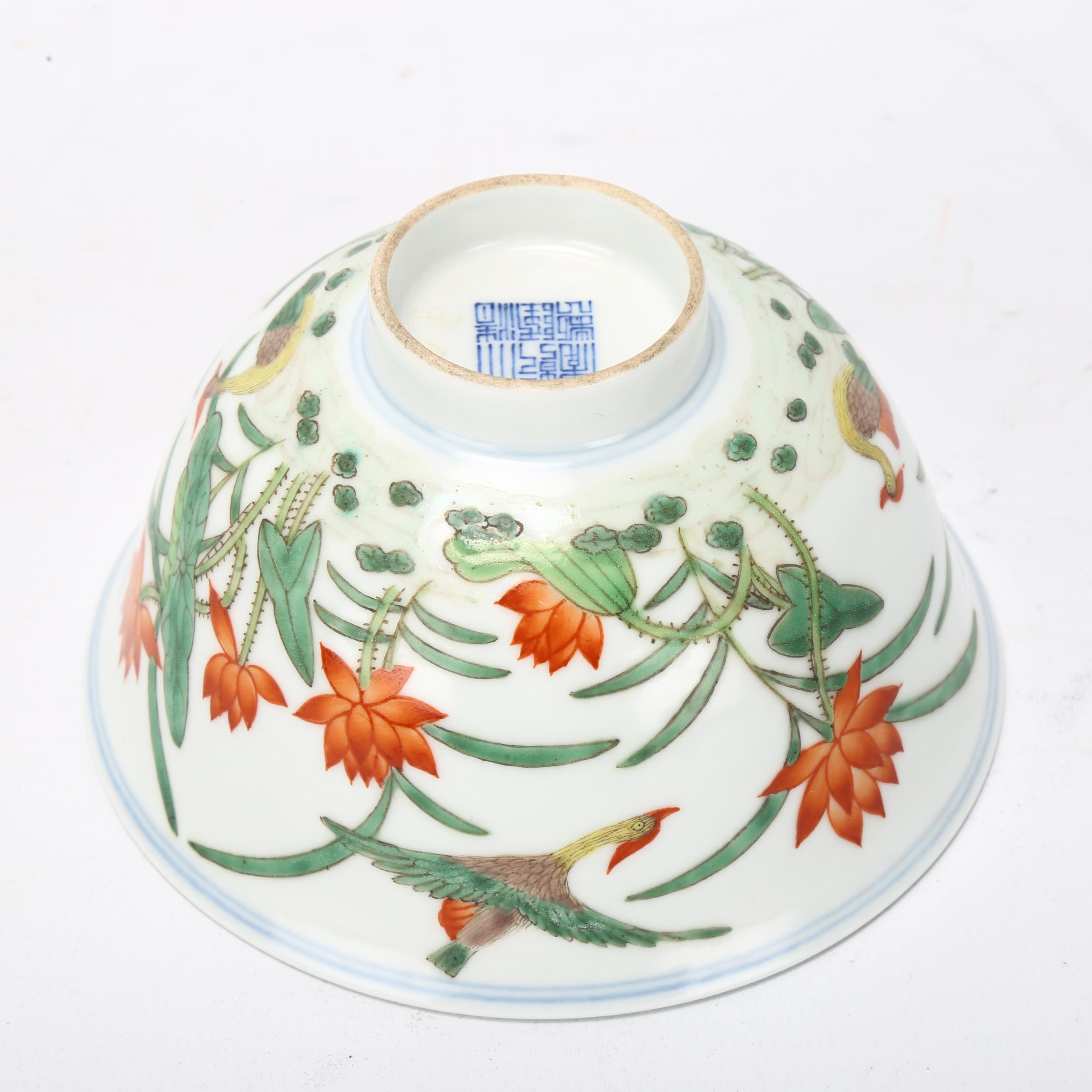 A Chinese porcelain bowl with painted duck and lily flower designs, Qianlong seal mark under, - Bild 2 aus 3