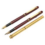 A pair of Morritz burgundy cased fountain pens, and a Cartier gold plated ballpoint pen (3) Good