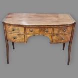 A Regency mahogany bow-front kneehole sideboard of small size, with 5 frieze drawers, original brass